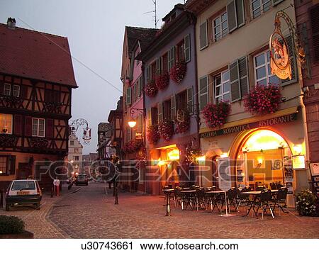 Stock Image -  France, Europe, Alsace, Colmar, Haut-Rhin, L'Alsace Wine Region, Route du Vin, downtown, evening, outdoor cafT. Fotosearch
