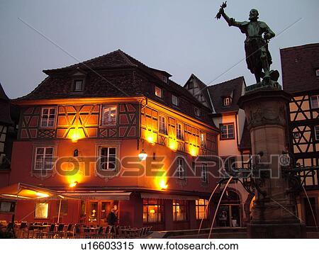 Stock Photography -  France, Europe, Alsace, Colmar, Haut-Rhin, L'Alsace Wine Region, Route du Vin, downtown, evening, half-timbered buildings, fountain. Fotosearch