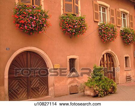 France, Europe, Alsace, Eguisheim, Haut-Rhin, L'Alsace Wine Region, Route du Vin, village, flowers decorate the front of a house, old wooden arched doors View Large Photo Image Picture - France, Europe, Alsace, Eguisheim, Haut-Rhin, L'Alsace Wine Region, Route du Vin, village, flowers decorate the front of a house, old wooden arched doors. Fotosearch