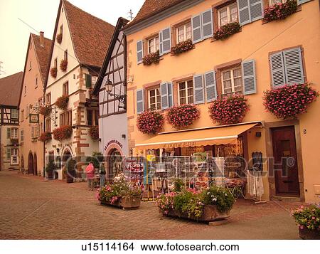 Picture -  France, Europe, Alsace, Eguisheim, Haut-Rhin, L'Alsace Wine Region, Route du Vin, downtown, half-timbered buildings, cobblestone pedestrian street. Fotosearch