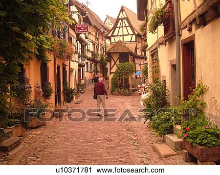 France, Europe, Alsace, Eguisheim, Haut-Rhin, L'Alsace Wine Region, Route du Vin, picturesque village, half-timbered buildings, narrow cobblestone pedestrian street View Large Photo Image Stock Image - France, Europe, Alsace, Eguisheim, Haut-Rhin, L'Alsace Wine Region, Route du Vin, picturesque village, half-timbered buildings, narrow cobblestone pedestrian street. Fotosearch
