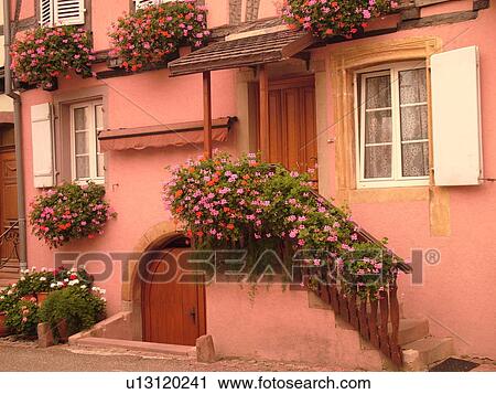 France, Europe, Alsace, Eguisheim, Haut-Rhin, L'Alsace Wine Region, Route du Vin, downtown, flowers decorate the front of a pink house View Large Photo Image Stock Image - France, Europe, Alsace, Eguisheim, Haut-Rhin, L'Alsace Wine Region, Route du Vin, downtown, flowers decorate the front of a pink house. Fotosearch