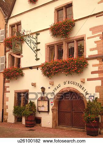 Stock Image -  France, Europe, Alsace, Eguisheim, Haut-Rhin, L'Alsace Wine Region, Route du Vin, downtown, Caveau D'Eguisheim, wooden arched door. Fotosearch