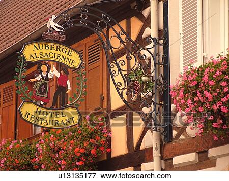 France, Europe, Alsace, Eguisheim, Haut-Rhin, L'Alsace Wine Region, Route du Vin, downtown, hanging sign of dancing Alsaciens and stork outside Auberge Alsacienne View Large Photo Image Stock Photo - France, Europe, Alsace, Eguisheim, Haut-Rhin, L'Alsace Wine Region, Route du Vin, downtown, hanging sign of dancing Alsaciens and stork outside Auberge Alsacienne. Fotosearch