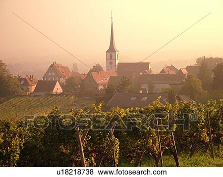Stock Photo -  France, Europe, Alsace, Itterswiller, Bas-Rhin, L'Alsace Wine Region, Route du Vin, village, vineyards, fog. Fotosearch
