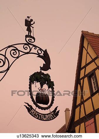 France, Europe, Alsace, Riquewihr, Haut-Rhin, L'Alsace Wine Region, Route du Vin, downtown, silhouette of hanging store sign View Large Photo Image Stock Image - France, Europe, Alsace, Riquewihr, Haut-Rhin, L'Alsace Wine Region, Route du Vin, downtown, silhouette of hanging store sign. Fotosearch