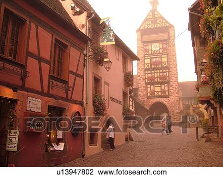 France, Europe, Alsace, Riquewihr, Haut-Rhin, L'Alsace Wine Region, Route du Vin, downtown, cobblestone pedestrian street, half-timbered buildings, clock tower View Large Photo Image Stock Image - France, Europe, Alsace, Riquewihr, Haut-Rhin, L'Alsace Wine Region, Route du Vin, downtown, cobblestone pedestrian street, half-timbered buildings, clock tower. Fotosearch