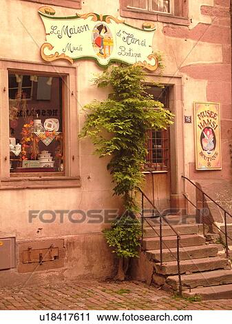 Stock Image -  France, Europe, Alsace, Riquewihr, Haut-Rhin, L'Alsace Wine Region, Route du Vin, downtown, La Maison de Hansi Musee Boutique. Fotosearch
