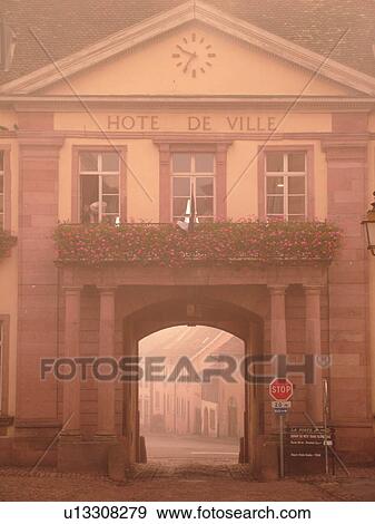 Stock Photo -  France, Europe, Alsace, Riquewihr, Haut-Rhin, L'Alsace Wine Region, Route du Vin, Hotel de Ville, downtown, fog. Fotosearch