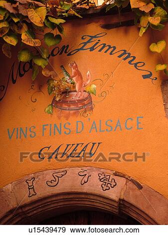 Stock Photo -  France, Europe, Alsace, Riquewihr, Haut-Rhin, L'Alsace Wine Region, Route du Vin, close-up, fatade, caveau, winery, wine tasting. Fotosearch