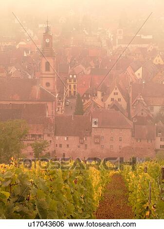 Stock Photograph -  France, Europe, Alsace, Riquewihr, Haut-Rhin, L'Alsace Wine Region, Route du Vin, vineyards, village, fog. Fotosearch
