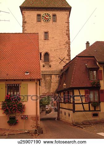Stock Image -  France, Europe, Alsace, St-Hippolyte, Haut-Rhin, L'Alsace Wine Region, Route du Vin, village, half-timbered building, gate. Fotosearch