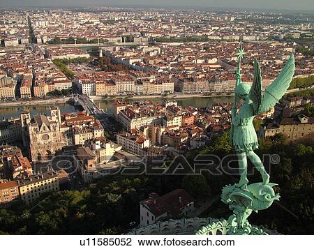 Stock Image -  France, Lyon, Rhone-Alpes, Europe, Saone River, aerial view of downtown Lyon from Fourviere Hill, religious statue. Fotosearch