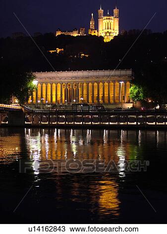 Stock Image -  France, Lyon, Rhone-Alpes, Europe, Palais de Justice, Saone River, Basilique Notre-Dame de Fourviere, evening, illuminated. Fotosearch