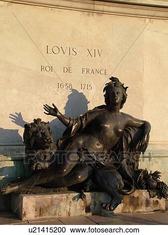 Stock Image -  France, Lyon, Rhone-Alpes, Europe, Statue of woman below the Equestrian statue of Louis XIV, Place Bellecour. Fotosearch