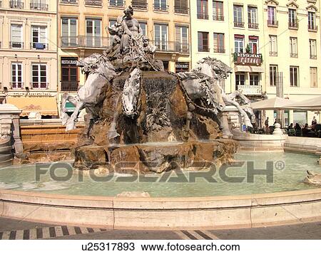 Stock Image -  France, Lyon, Rhone-Alpes, Europe, downtown, 19th century fountain, four horses pulling the chariot, Place des Terreaux. Fotosearch