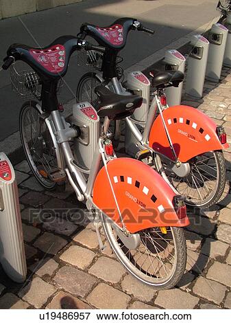 Stock Photo -  France, Lyon, Rhone-Alpes, Europe, downtown, bicycle rentals. Fotosearch