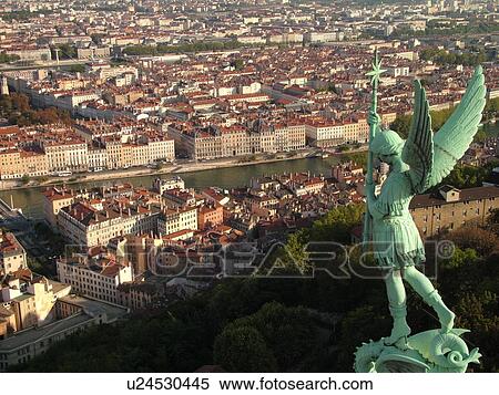 Stock Photography -  France, Lyon, Rhone-Alpes, Europe, Saone River, aerial view of downtown Lyon from Fourviere Hill, religious statue. Fotosearch