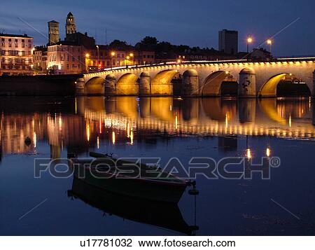 Stock Image -  France, Macon, Burgundy, Saone et Loire, Europe, Saone River, The 11th century Pont de St-Laurent, evening. Fotosearch
