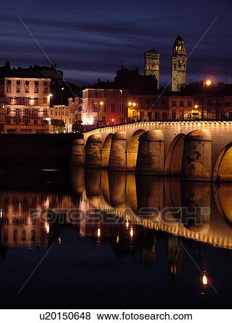 Stock Photo -  France, Macon, Burgundy, Saone et Loire, Europe, Saone River, The 11th century Pont de St-Laurent, evening. Fotosearch