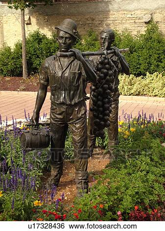 Stock Photograph -  France, Marsannay la Cote, Burgundy, Cote de Nuits, Cote d'Or, Europe, Burgundy Wine Region, wine harvest statue, men carrying grapes. Fotosearch