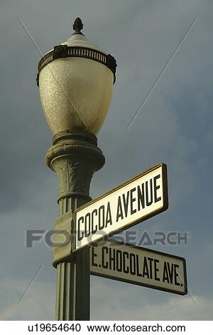Stock Image -  Hershey, PA, Pennsylvania, Cocoa Avenue and East Chocolate Avenue road sign on a black lamp post. Fotosearch