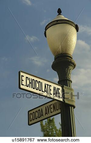 Stock Photo -  Hershey, PA, Pennsylvania, Cocoa Avenue and East Chocolate Avenue road sign on a black lamp post. Fotosearch