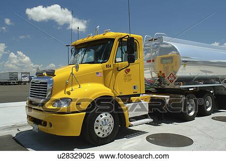 Stock Photography -  Heyburn, ID, Idaho, I-84, gas station, yellow Freightliner cab, truck, 18-wheeler, tanker. Fotosearch