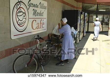 Stock Photo -  Millersburg, Holmes County, OH, Ohio, Amish woman, bicycle, German Village Market. Fotosearch
