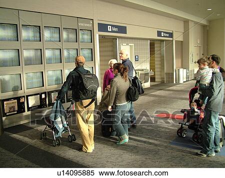 Stock Photography -  Minneapolis, MN, Minnesota, Minneapolis International Airport, airport information, flight arrivals and departure monitors, airport terminal, hub, people looking at monitors. Fotosearch