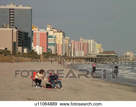 Myrtle Beach, SC, South Carolina, The Grand Strand, Atlantic Ocean, skyline, Couple riding horses on beach, couple relaxing View Large Photo Image Stock Photo - Myrtle Beach, SC, South Carolina, The Grand Strand, Atlantic Ocean, skyline, Couple riding horses on beach, couple relaxing. Fotosearch