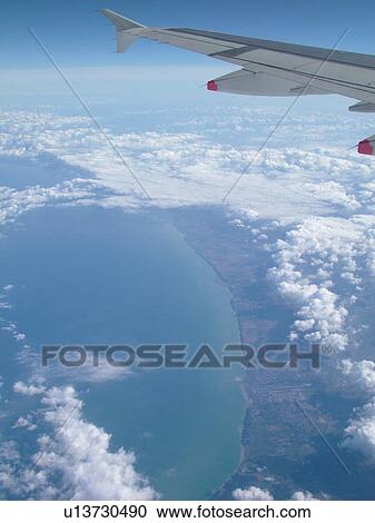 Stock Image -  Normandy, France, Europe, aerial, flying over the coast of Normandy, English Channel, British Airways plane, wing. Fotosearch