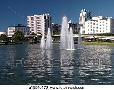 Stock Image -  Orlando, FL, Florida, Lake Lucerne, skyline, downtown, fountain. Fotosearch
