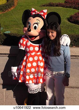 Orlando, FL, Florida, Walt Disney World Resort, Magic Kingdom Park, Minnie Mouse poses with little girl for pictures (Editorial Use Only) View Large Photo Image Stock Image - Orlando, FL, Florida, Walt Disney World Resort, Magic Kingdom Park, Minnie Mouse poses with little girl for pictures (Editorial Use Only). Fotosearch
