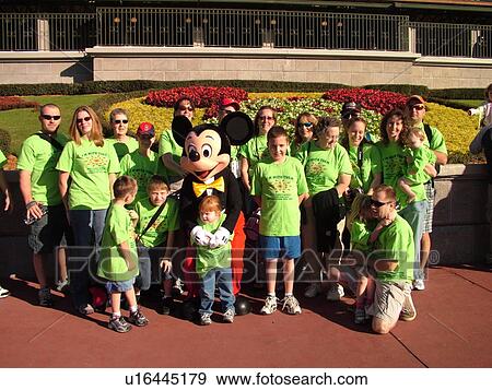 Stock Photo -  Orlando, FL, Florida, Walt Disney World Resort, Magic Kingdom Park, Minnie Mouse poses with group of people for pictures (Editorial Use Only). Fotosearch