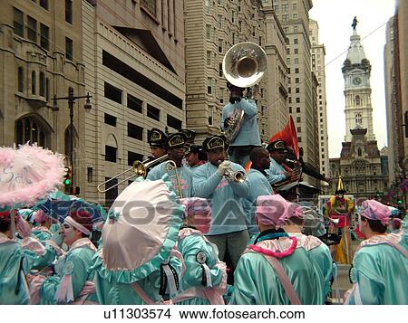 Picture -  Philadelphia, PA, Pennsylvania, downtown, New Years Day, Philadelphia Annual Mummer's Day Parade, 2006, Royal Brass Band, comic division, men in blue and pink dresses strutting with umbrellas. Fotosearch