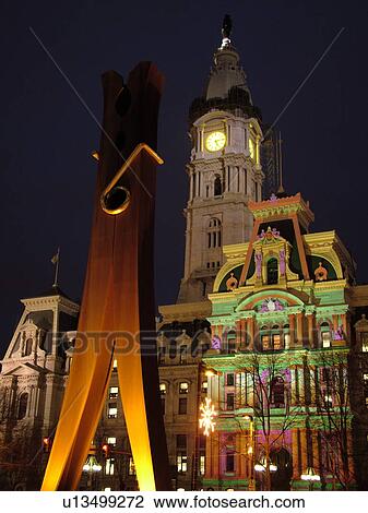 Stock Image -  Philadelphia, PA, Pennsylvania, downtown, evening, City Hall, Clothes Pin statue, colorful lights on building. Fotosearch