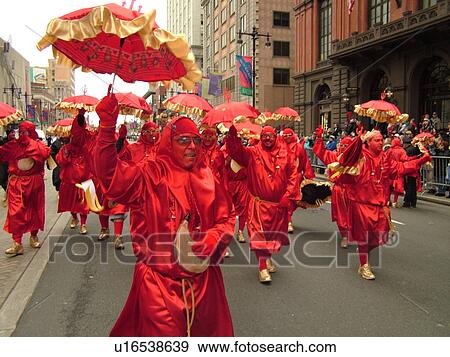 Stock Photo -  Philadelphia, PA, Pennsylvania, downtown, New Years Day, Philadelphia Annual Mummer's Day Parade, 2006, Comic Division, men in red dresses strutting with umbrellas, satan, devils. Fotosearch