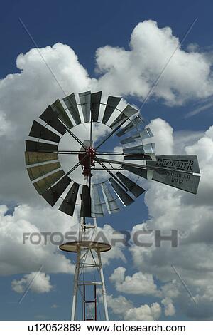 Stock Photo -  Pocatello, ID, Idaho, Upper Ross Park, Fort Hall Replica, windmill, blue sky, white clouds. Fotosearch