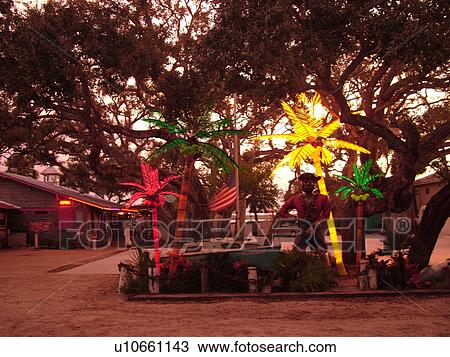 Stock Image -  Ponce Inlet, Daytona Beach, FL, Florida, Atlantic Ocean, Ponce De Leon Inlet, Lighthouse Point Park, restaurant, evening, pirate and lighted palm tree decorations. Fotosearch