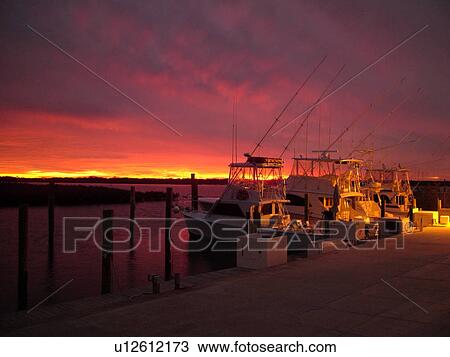 Stock Image -  Ponce Inlet, Daytona Beach, FL, Florida, Atlantic Ocean, Ponce De Leon Inlet, Inlet Harbor Marina, sunset, fishing boats. Fotosearch