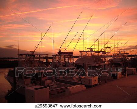 Stock Photo -  Ponce Inlet, Daytona Beach, FL, Florida, Atlantic Ocean, Ponce De Leon Inlet, Lighthouse Point Park, Inlet Harbor Marina, sunset, fishing boats. Fotosearch