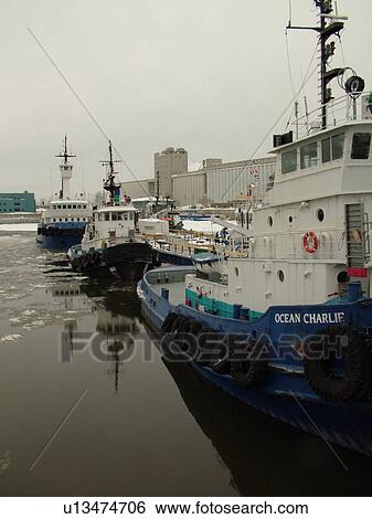 Stock Photograph -  Quebec City, Quebec, Canada, Saint Lawrence River, Fleuve St-Laurent, Vieux Port, tug boats, winter, ice. Fotosearch