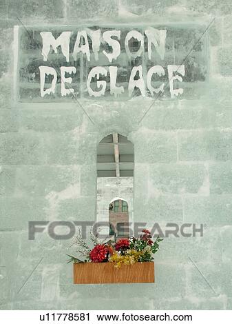 Stock Image -  Quebec City, Quebec, Canada, Winter Carnival 2006, Maison de Glace, Ice House, window box with flowers, snow. Fotosearch
