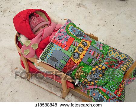 Quebec City, Quebec, Canada, Winter Carnival 2006, snow, baby bundled up in wooden sled View Large Photo Image Stock Photo - Quebec City, Quebec, Canada, Winter Carnival 2006, snow, baby bundled up in wooden sled. Fotosearch