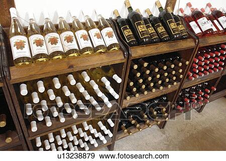 Stock Photo -  Romulus, NY, New York, Finger Lakes, Swedish Hill Winery, wines, racks. Fotosearch