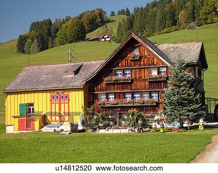 Stock Image -  Switzerland, Europe, Appenzell, typical Appenzell farmhouse and barn combined. Fotosearch