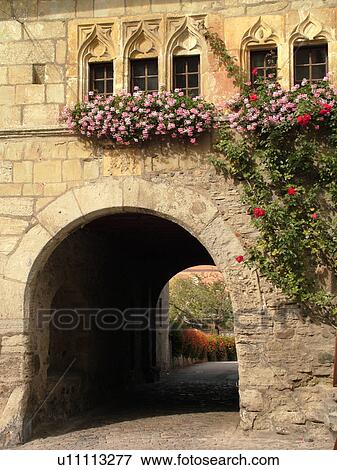 Stock Photo -  Switzerland, Europe, Fribourg, Estavayer le Lac, Chateau de Chenaux, village, windows, pink geraniums in windowboxes, archway. Fotosearch