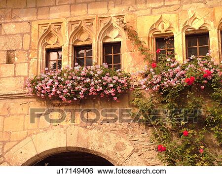 Stock Photograph -  Switzerland, Europe, Fribourg, Estavayer le Lac, Chateau de Chenaux, village, windows, pink geraniums in windowboxes, stonewall. Fotosearch
