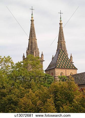 Stock Image -  Switzerland, Europe, Neuchatel, La Collegiale, Romanesque-Gothic 12th century church, steeples. Fotosearch